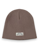 Zestaw czapka beanie i komin dla chłopca od PanPan 35 to brązowy, prążkowany bawełniany zestaw idealny na wiosnę, dodający stylu i wygody dzięki białym naszywkom.